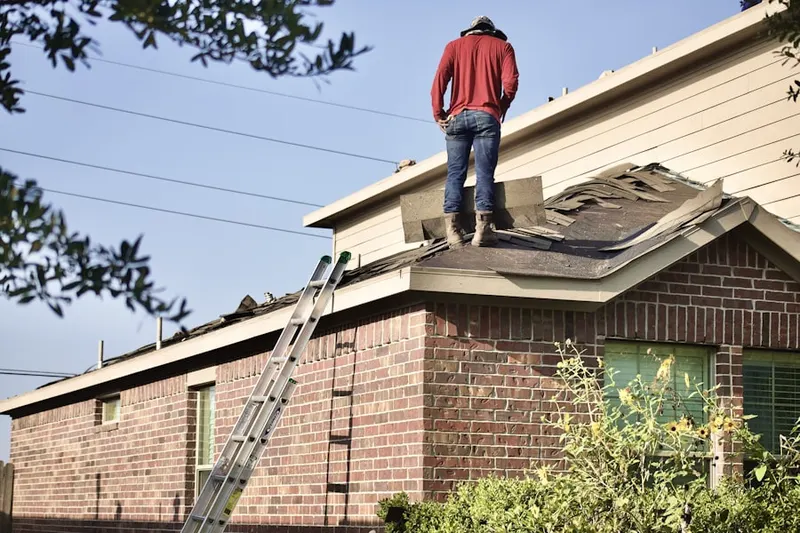 Professional roofer working on a residential roof in East Bethel